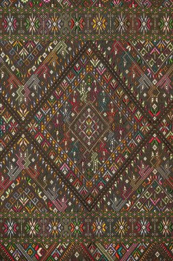 Colorful thai handcraft peruvian style rug surface old vintage torn conservation Made from natural materials Chemical free close up.