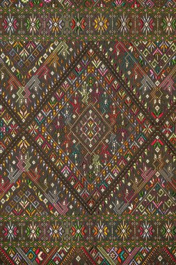 Colorful thai handcraft peruvian style rug surface old vintage torn conservation Made from natural materials Chemical free close up.