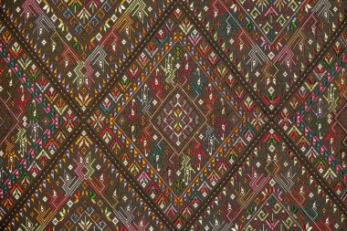 Colorful thai handcraft peruvian style rug surface old vintage torn conservation Made from natural materials Chemical free close up.