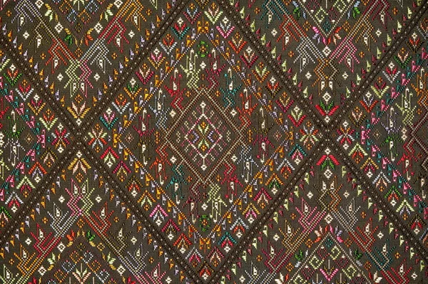 Colorful thai handcraft peruvian style rug surface old vintage torn conservation Made from natural materials Chemical free close up.