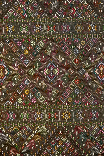 Colorful thai handcraft peruvian style rug surface old vintage torn conservation Made from natural materials Chemical free close up.