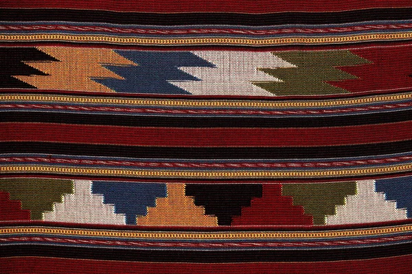 Colorful thai handcraft peruvian style rug surface old vintage torn conservation Made from natural materials Chemical free close up.