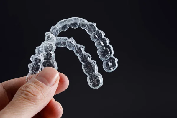 Hand Holding Two Transparent Retainers Black Background Invisalign Orthodontics Concept — Stock Photo, Image