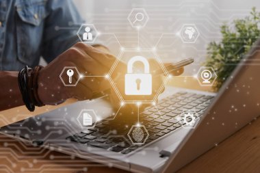 Casual Businessman Hand Touching Mobile Phone or Smart Phone Screen and Center Hexagon Lock Security Sign and Laptop Computer. Secure or Firewall and Protection Concept