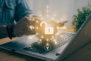 Casual Businessman Hand Touching Mobile Phone or Smart Phone Screen and Circle Unlock Security Sign and Laptop Computer. Secure or Firewall and Protection Concept in Vintage Tone