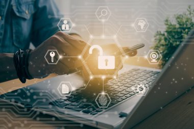 Casual Businessman Hand Touching Mobile Phone or Smart Phone Screen and Hexagon Unlock Security Sign and Laptop Computer. Secure or Firewall and Protection Concept in Vintage Tone