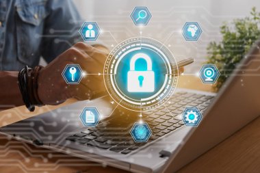 Casual Businessman Hand Touching Mobile Phone or Smart Phone Screen and Blue Hexagon Lock Security Sign and Laptop Computer. Secure or Firewall and Protection Concept