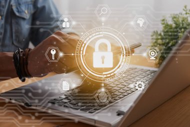Casual Businessman Hand Touching Mobile Phone or Smart Phone Screen and Hexagon Lock Security Sign and Laptop Computer. Secure or Firewall and Protection Concept