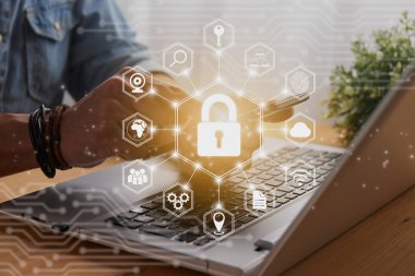 Casual Businessman Hand Touching Mobile Phone or Smart Phone Screen and Hexagon Lock Security Sign and Laptop Computer. Secure or Firewall and Protection Concept