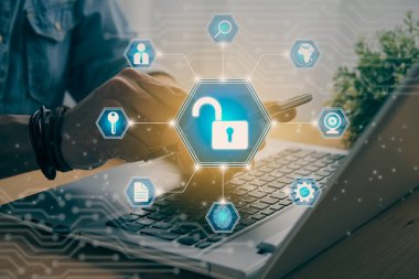 Casual Businessman Hand Touching Mobile Phone or Smart Phone Screen and Blue Hexagon Unlock Security Sign and Laptop Computer. Secure or Firewall and Protection Concept in Vintage Tone