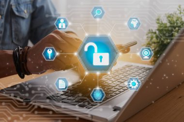Casual Businessman Hand Touching Mobile Phone or Smart Phone Screen and Blue Hexagon Unlock Security Sign and Laptop Computer. Secure or Firewall and Protection Concept