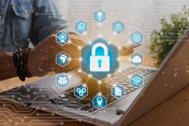 Casual Businessman Hand Touching Mobile Phone or Smart Phone Screen and Blue Hexagon Lock Security Sign and Laptop Computer. Secure or Firewall and Protection Concept