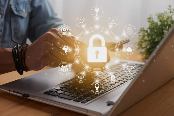 Casual Businessman Hand Touching Mobile Phone or Smart Phone Screen and Circle Lock Security Sign and Laptop Computer. Secure or Firewall and Protection Concept