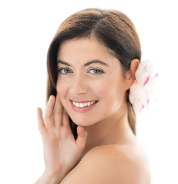 Attractive woman in her forties with a flower — Stock Photo, Image