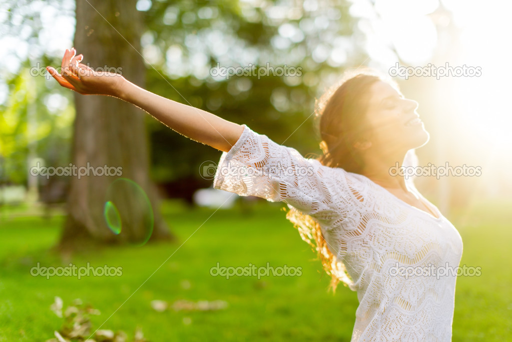 Multi-ethnic girl enjoying the warmth of a sunset