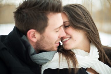 Young couple being affectionate in winter