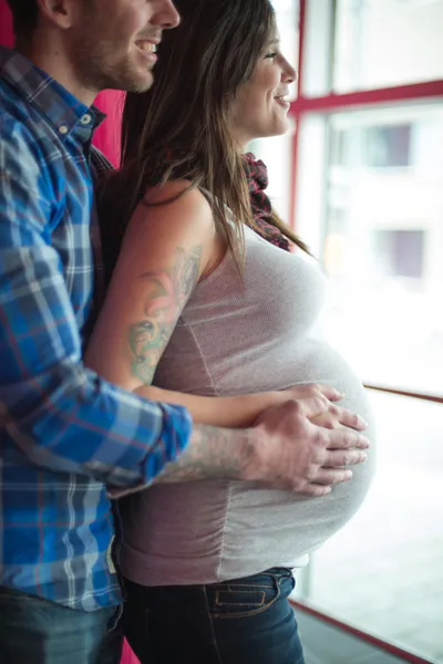 Trendy couple being holding the pregnant belly — Stock Photo, Image