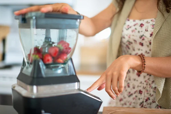 Health conscious woman using a blender — Stock Photo, Image