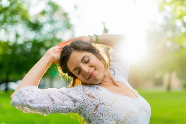 Mixed race woman feeling freedom in a sun flare — Stock Photo, Image