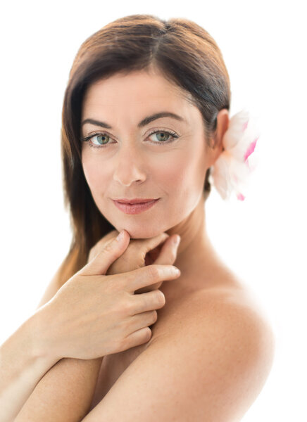 Attractive woman in her forties with a flower