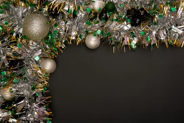 Christmas tinsel is on black background. — Stock Photo, Image