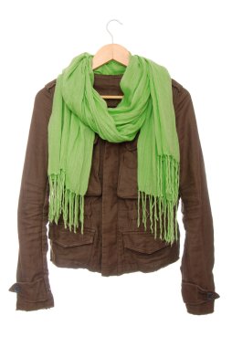 Brown jacket and green scarf are on hanger. clipart