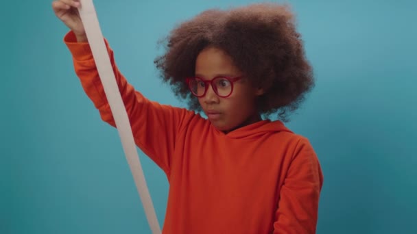 Megdöbbent afro-amerikai lány kíváncsi nagy számlát vagy számlát. Meglep, hogy egy gyerek átnézi a blokkot. A hazai költségvetés számviteli koncepciója. — Stock videók