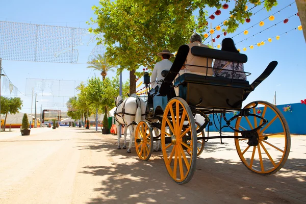 People in a horse carriage at the fair in Spain. — Stock Photo, Image