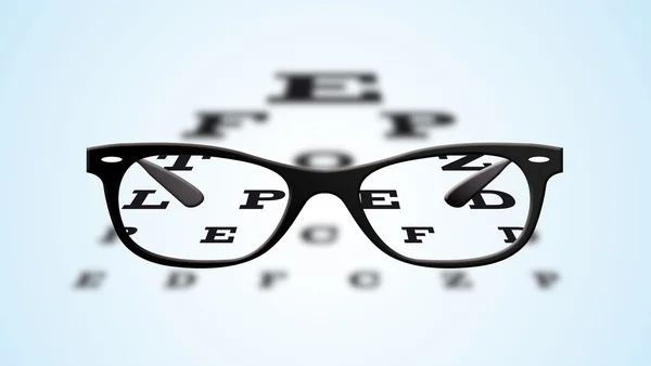 Eyeglasses over a blurry eye chart — Stock Photo, Image