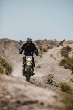 Almeria, Spain - May 5th 2021: Motocross rider riding downhill in Tabernas desert during Dunlop Xperience showroom and test in Almeria, Spain.