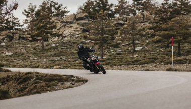 Calar Alto, İspanya - 5 Mayıs 2021: Almerya, İspanya 'da Dunlop Xperience etkinliği sırasında, güzel bir dağ silsilesinde Yamaha XSR700 motosikleti süren adam.