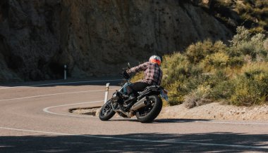 Almerya, İspanya - 5 Mayıs 2021: Almerya dağ sırasındaki Dunlop Xperience etkinliği sırasında, bir dağ yolunda BMW R NineT motorsikletine binen adam, İspanya.