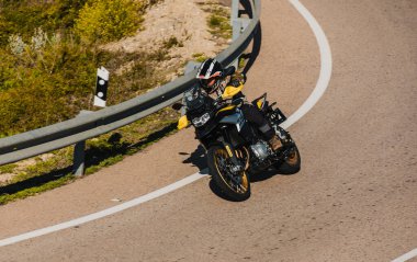 Almerya, İspanya - 5 Mayıs 2021: Almerya, İspanya 'da Dunlop Xperience etkinliği sırasında bir dağ yolunda BMW 850 GS siyah ve sarı motosiklet süren adam.