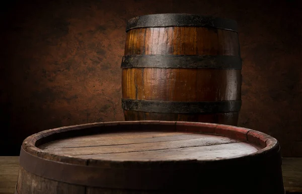 Beer. Still life with Vintage beer barrel and glass light beer. Fresh amber beer concept. Green hop and gold barley on wooden table. Ingredients for brewery. Brewing traditions