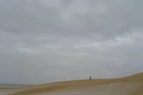 Un enfant marchant sur les sables des dunes dans le désert seul — Photo