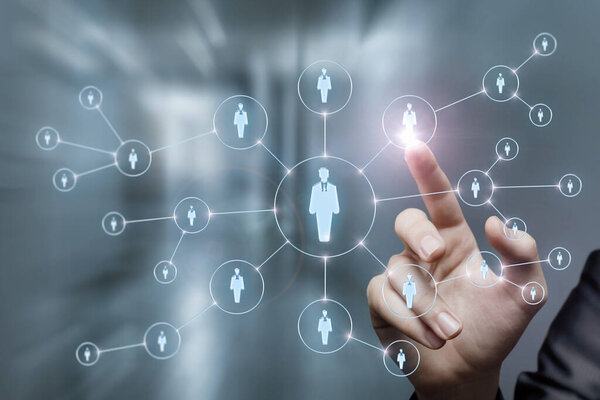Businessman clicks on employee in human resource network on blurred background.