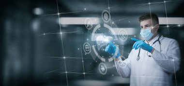 Young medical worker working on virtual computer screen with liver diagnostics interface.