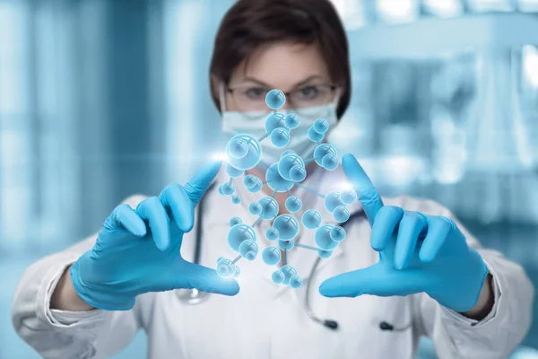 Molecular research concept. A laboratory assistant manipulates a molecule on a blurred background.
