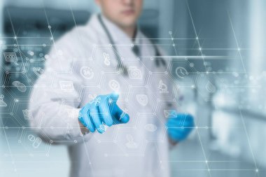 Doctor working on virtual computer screen with medical interface on blurred background.