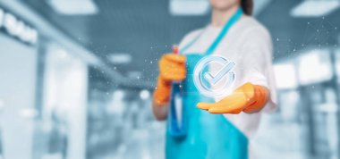 Cleaning lady show high quality work on a blurred background.