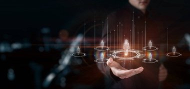 Businessman shows a network of human resources on a blurred dark background.