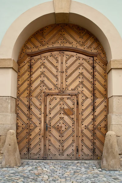 Brown Wooden door set in a Large Door — Stock Photo, Image