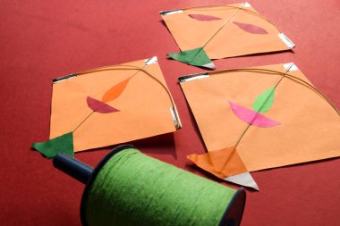 Kites and spool on red background. Makar sankranti Indian festival posters for Uttarayan, Lohri and Pongal. Kite festival. Patang aur Manjha