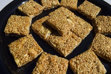 Cholai ki chikki or Rajgira chikki made from Amaranth seeds and Jaggery. Makar sankranti Indian festival fasting sweets food.