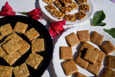 Tasty Indian sankranti special sweets Chiiki. Three types of chikkis like Peanut, Rajgira or Amaranth and Crushed peanut chikki bars