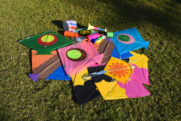 Sankranti kites patang flying outdoors. Colorful kites during kite festival. Makar sankranti festival celebrations. Kites on ground