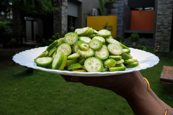 spiny gourd, kantola, spinygourd, gourds, types of gourds, variety, indian vegetables, vegetables, green vegetables, cut, chopped, sliced, indian, asian, asian vegetables, asia, curry, plate, top view, round, indian fruits, fruits, raw, organic, heal