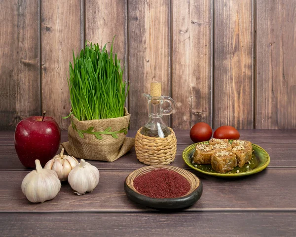 Festive table in honor of Navruz. Wheat with a red ribbon, the traditional holiday of the vernal equinox Nawruz — Stock Photo, Image