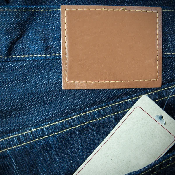 Jeans pocket and paper tag on blue denim — Stock Photo, Image