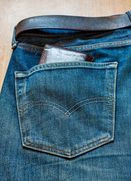 Blue jeans pocket with Wallet brown — Stock Photo, Image